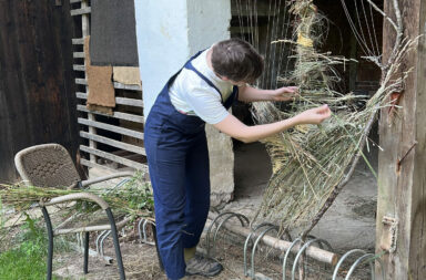 Fibre artist, Gina van der Ploeg, weaving with grasses