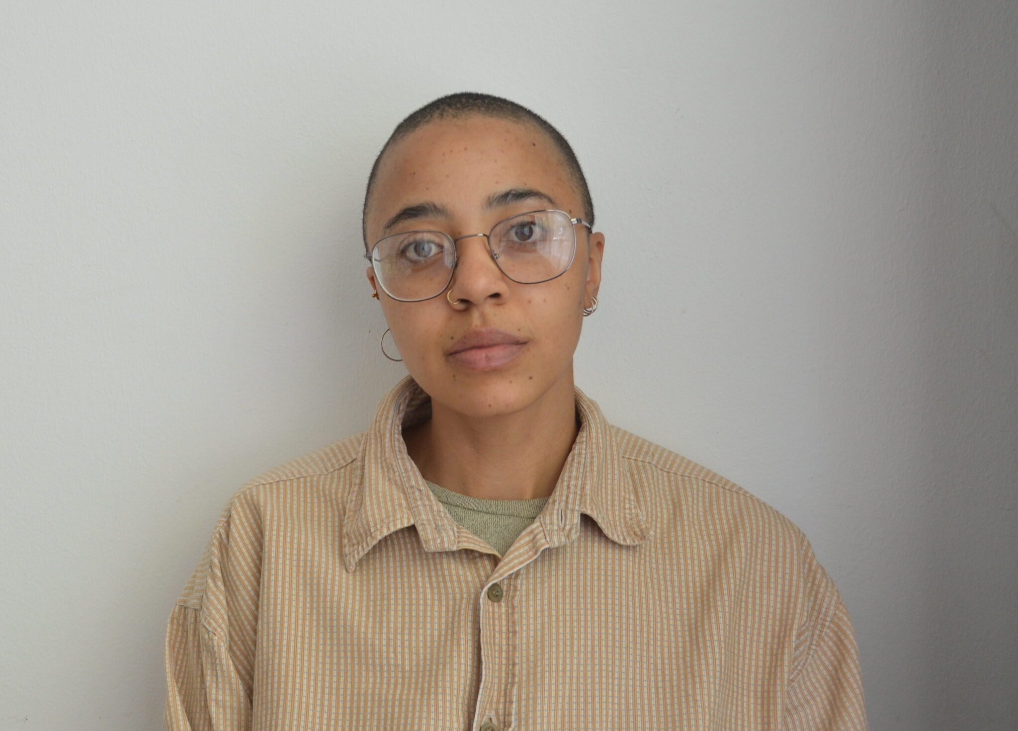 Thulile Gamedze is a Johannesburg-based cultural worker engaged in text, textile and history, and interested in the possibilities that emerge through the collapse of discipline. Through the workings of the 'aftercycle', Thuli's brand FOR THE AFTERLIFE (FTA) experiments with found textile and one-of-one wear. FTA's close material work has ultimately prompted her broader art practice, which is interested in the ghosts of the secondhand realm, and the formal, historic, political and social meanings in (soft) design. Her ongoing artistic and social history project After Library works these ideas into a collaborative reading and archival project engaging ongoing clothing loans. Having piloted in Johannesburg in 2025, the library brings together people with garment design, situated reading, and the documentation of practices of wear. She is currently furthering the research, design and archival practices of the After Library as a PhD candidate at the University of the Western Cape.